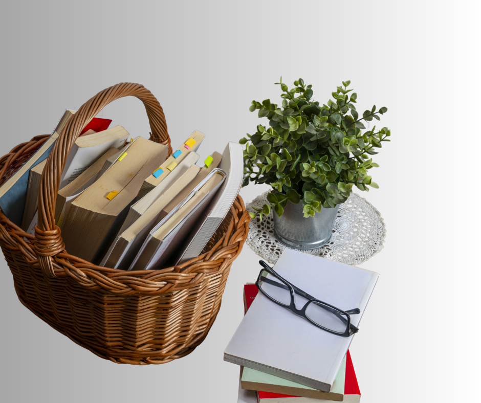 Photo has a basket of books, small houseplant, and a stack of books with reading glasses on top.