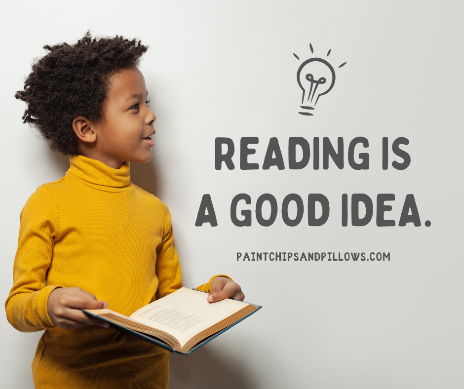 This photo of a boy holding an open book and smiling says, "Reading is a good idea."